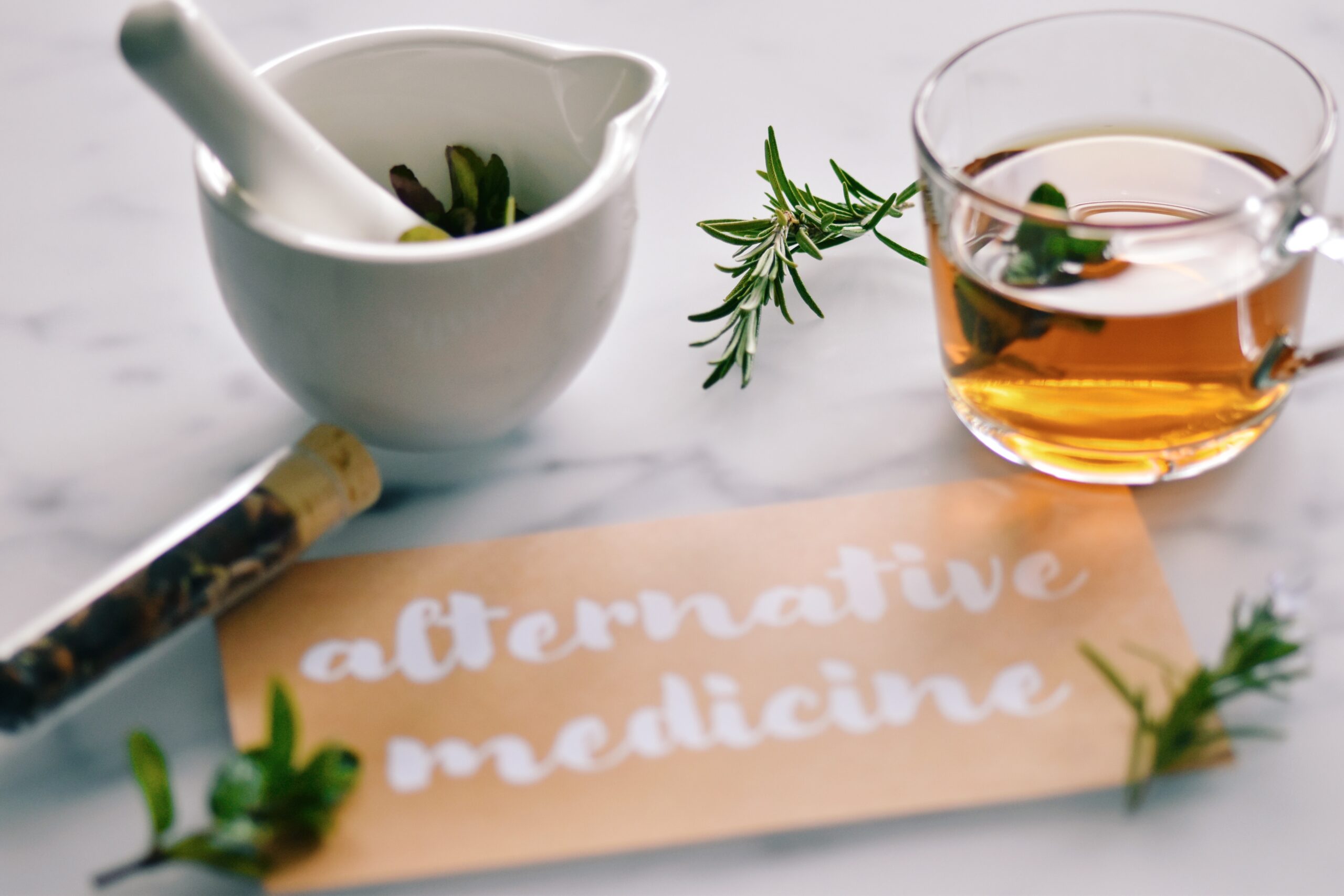 Herbal tea, mortar and pestle with fresh herbs and an alternative medicine sign — alternative medicine cancer support Healing Hub
